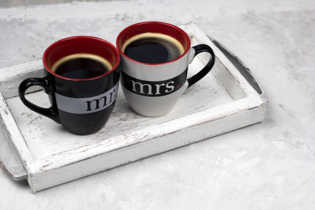 two cups of black coffee on vintage wooden tray concrete background