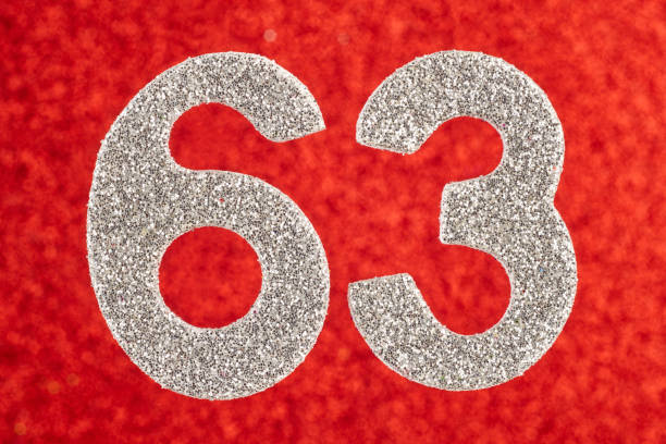 istock Number sixty-three silver color over a red background. Anniversary 944511544