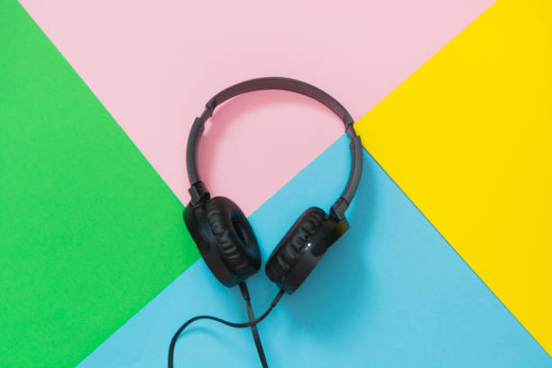 istock Modern style black headphones on colorful background. 944512372