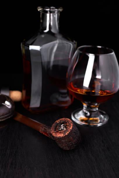 istock Glass of whiskey with smoking cigar. 944512828