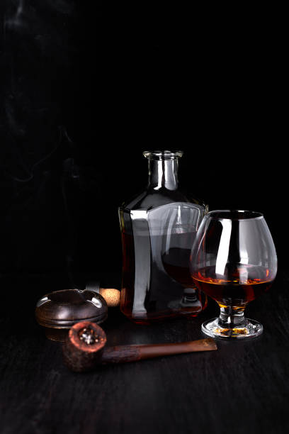 istock Glass of whiskey with smoking cigar. 944512830