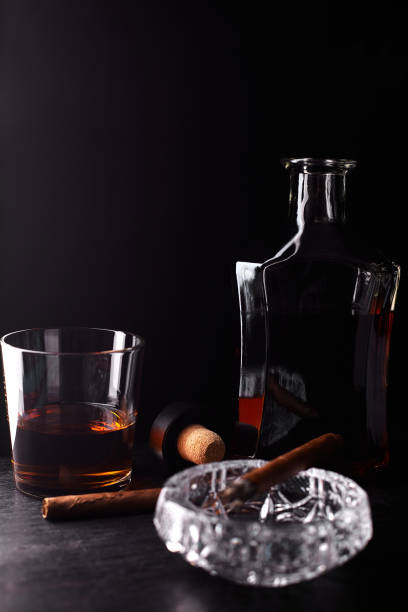 istock Glass of whiskey with smoking cigar. 944513238