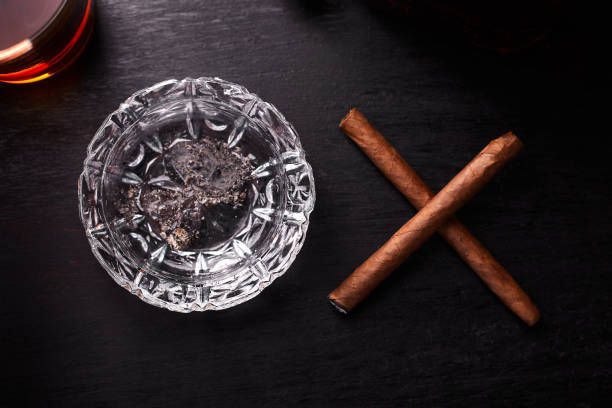 istock Glass of whiskey with smoking cigar. 944513538
