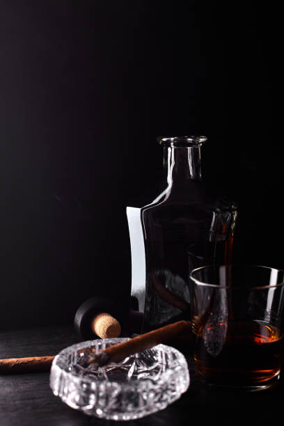 istock Glass of whiskey with smoking cigar. 944514870