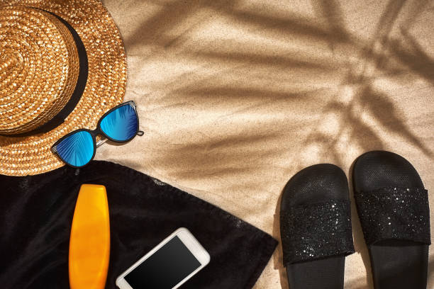 istock Summer background with straw hat, sunglasses, sunscreen bottle and flip flops 944516360