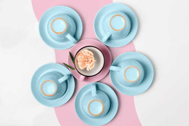 istock Elegant porcelain blue and pink cups turned upside down on abstract background 944518948