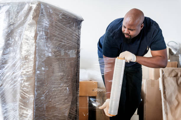 istock Black man moving furniture alone 944526428