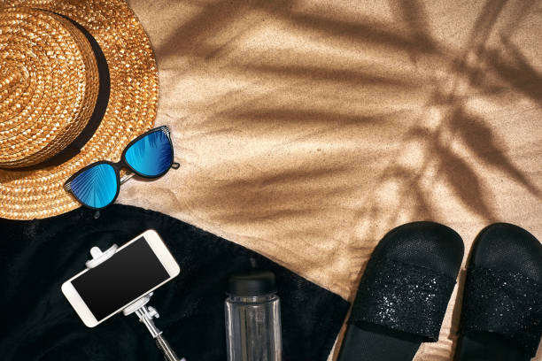 istock Summer background with straw hat, sunglasses, sunscreen bottle and flip flops 944526536