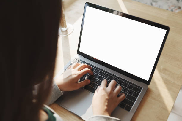 istock Man using laptop with blank screen at table in the office. 944530678