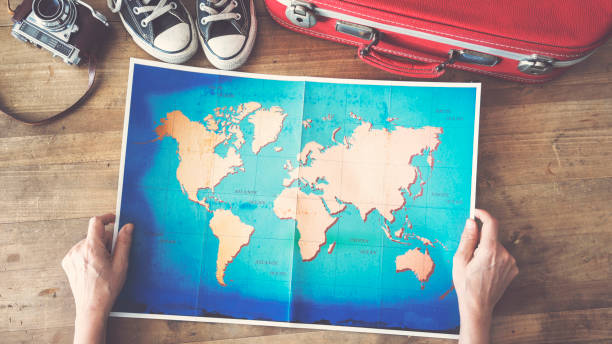 istock Woman holding map travel concepts 944531094