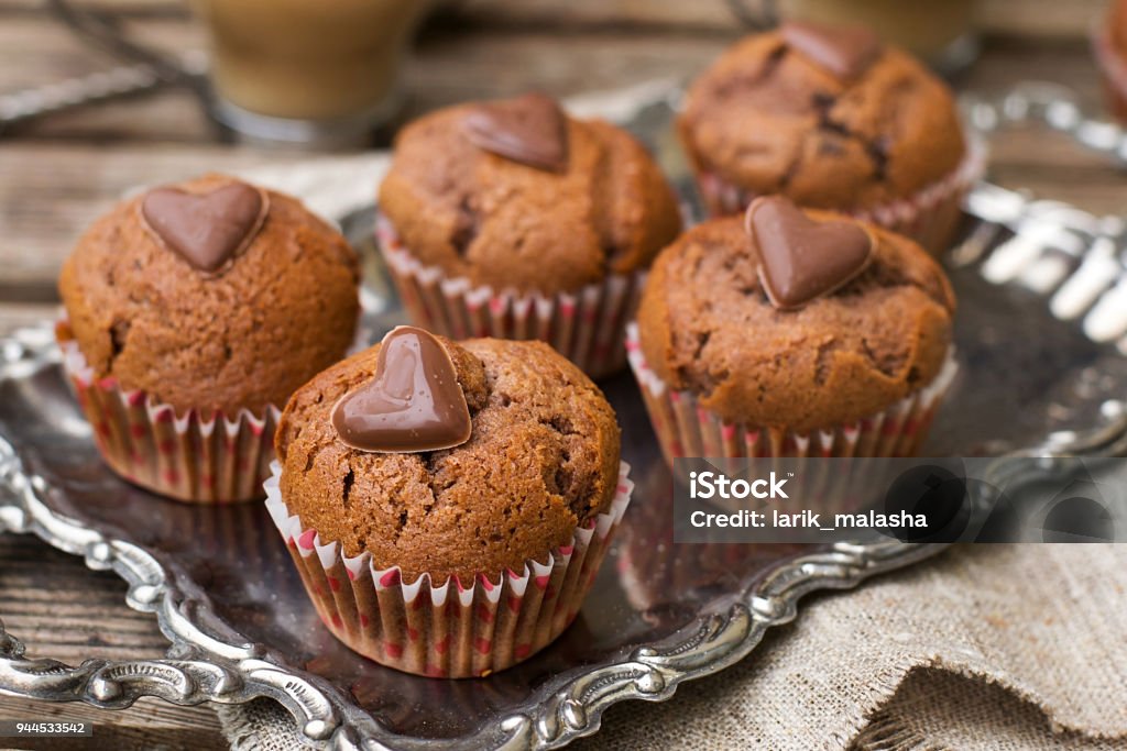 Chocolate muffins with chocolate chips and chocolate heart Sweet chocolate muffins with chocolate chips and chocolate heart Baked Stock Photo