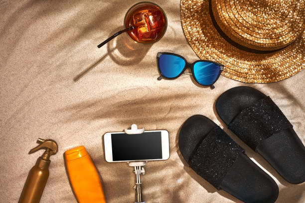 istock Summer background with straw hat, sunglasses, sunscreen bottle and flip flops 944533552