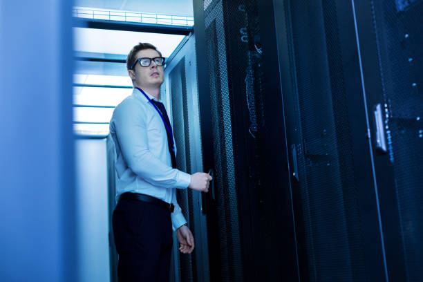 istock Serious worker standing in the office 944534402