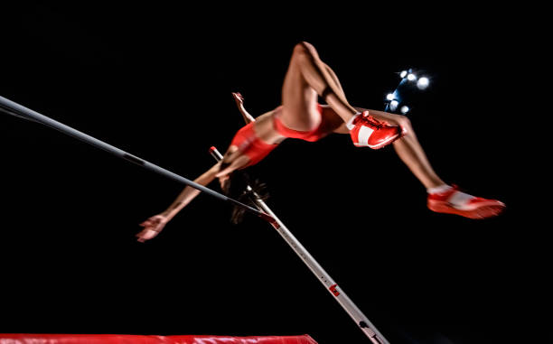istock Female high jumper jumping over bar 944535200