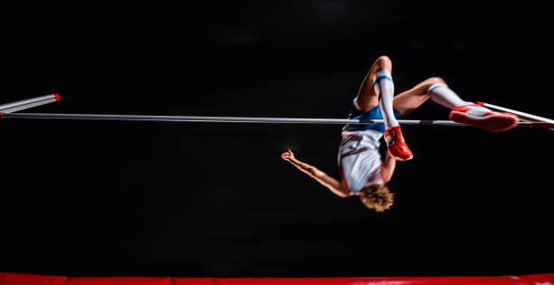 istock Male high jumper jumping over bar 944535208