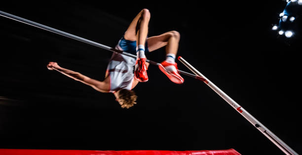 istock Male high jumper jumping over bar 944535212