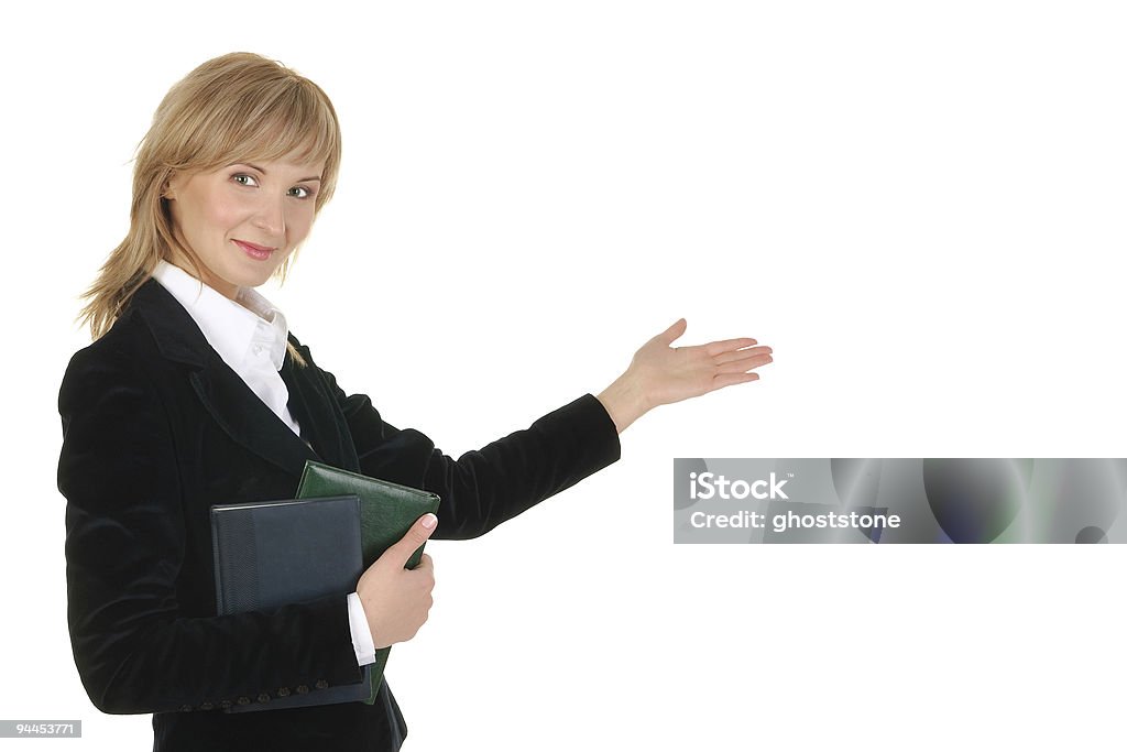 Portrait of businesswoman  pointing at wall .  Adult Stock Photo