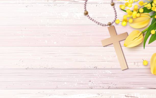 istock Cross, beads, mimosa branch and yellow tulips on rustic wooden background. 944539002