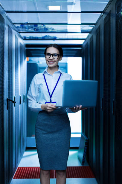 istock Joyful woman holding her laptop 944539026