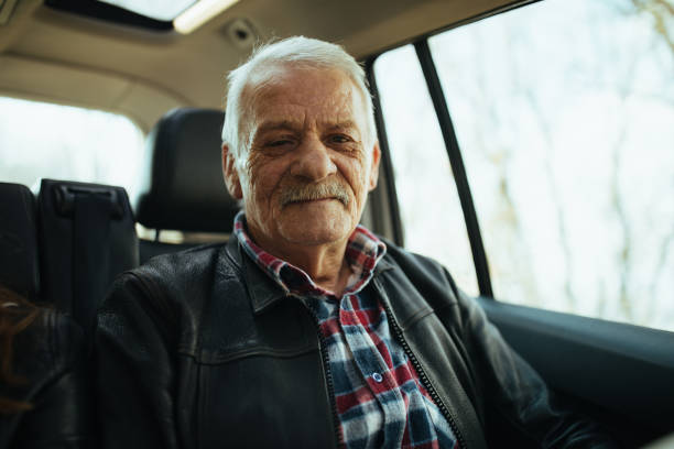 istock Senior man on back car seat 944539036