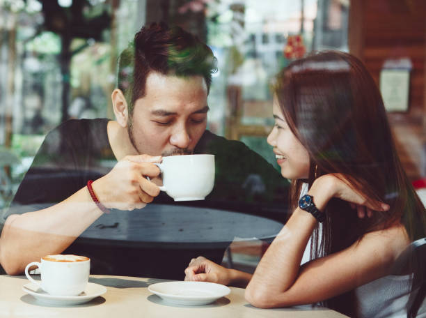 istock Lovely asian couple having coffee 944539240