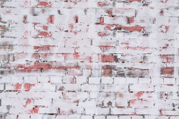 wall texture with brick patterns with unevenly painted white paint, abstract background - unevenly imagens e fotografias de stock