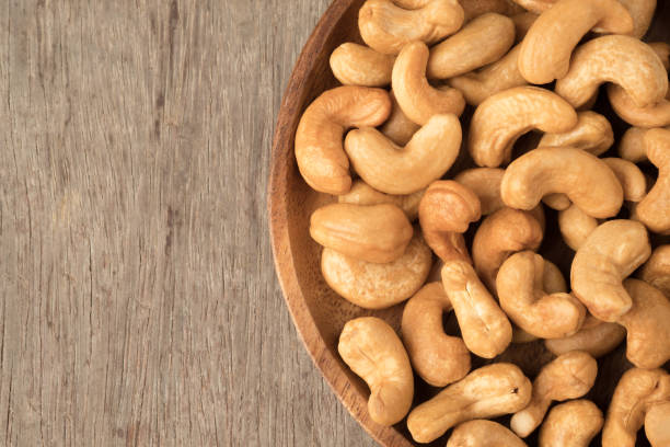 istock Cashew nuts in wooden bowl  on woden table. 944540254