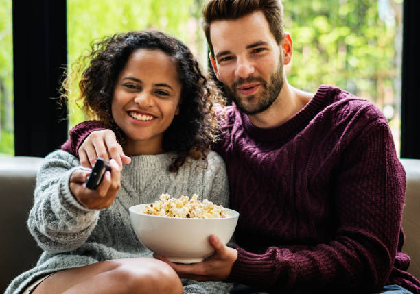 istock Couple watching tv on the sofa 944542204
