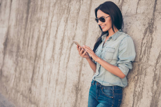 istock Portrait of pretty brunette read email on her smartphone and  using 4g internet 944542898