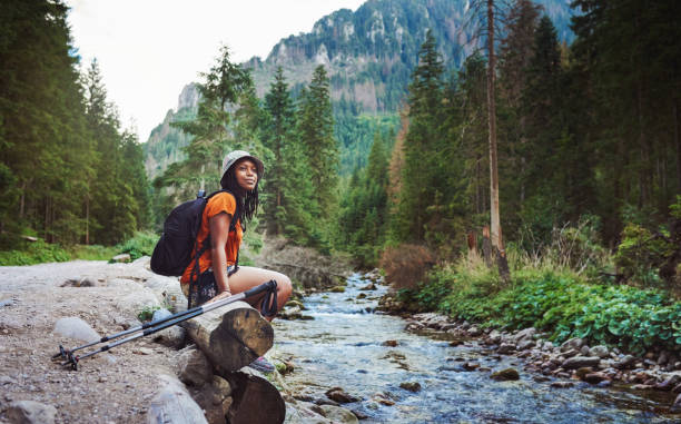 Her favourite spot to trek to Shot of a young attractive woman hiking in nature travel lifestyle stock pictures, royalty-free photos & images