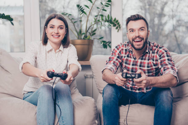 istock Young happy couple having date and playing video games 944547062