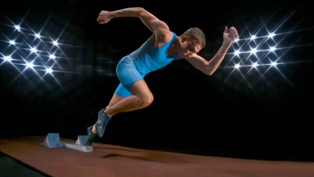 istock Male sprinter leaving starting blocks 944550460
