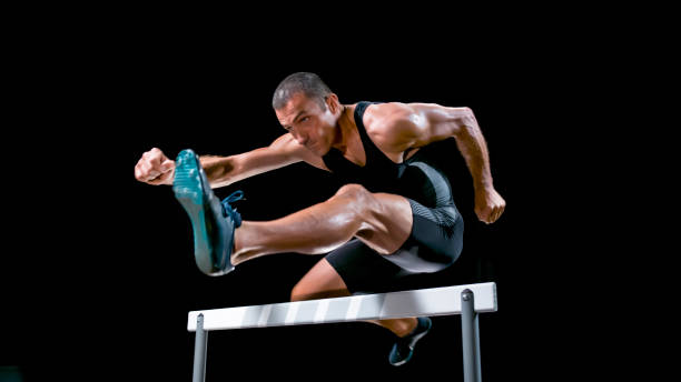 istock Male hurdler jumping over hurdle 944550466