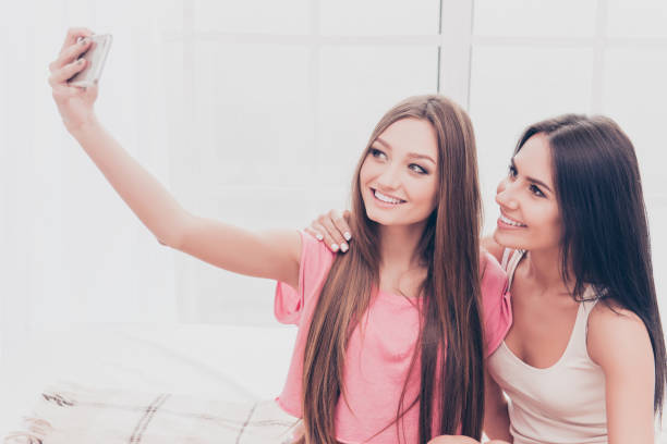 istock Happy beautiful best girlfriends making selfie onj smartphone 944553924
