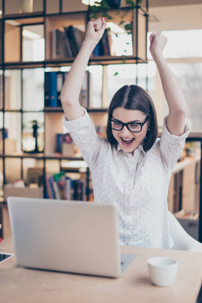 istock Happy glad female manager triumphing with raised hands 944554782