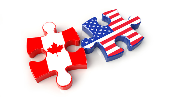 USA and Canada flags on puzzle pieces. Political relationship concept. 3D rendering