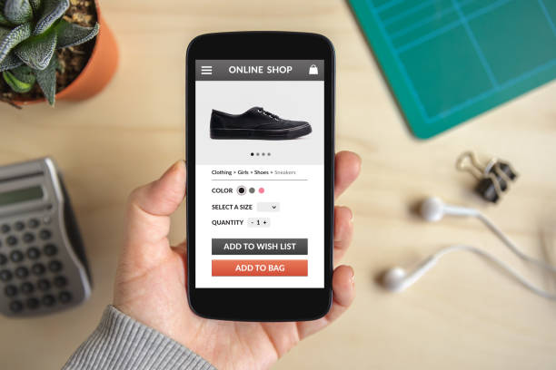 istock Hand holding smart phone with online shop concept on screen 944557514