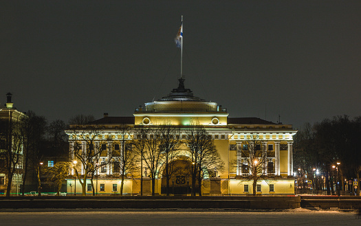 A picture of the Admiralty Building at night taken from the other side of the Neva river.