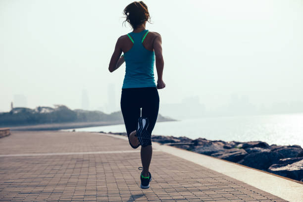 istock fitness sportswoman running on coast 944565122