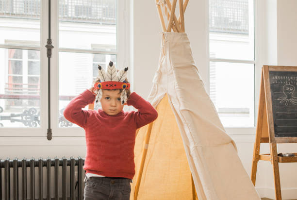 boy wearing an indian costume - halloween color image horizontal side view imagens e fotografias de stock