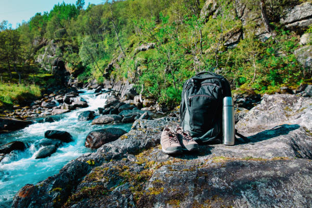 istock backpack, hiking boots and thermos in nature 944566020