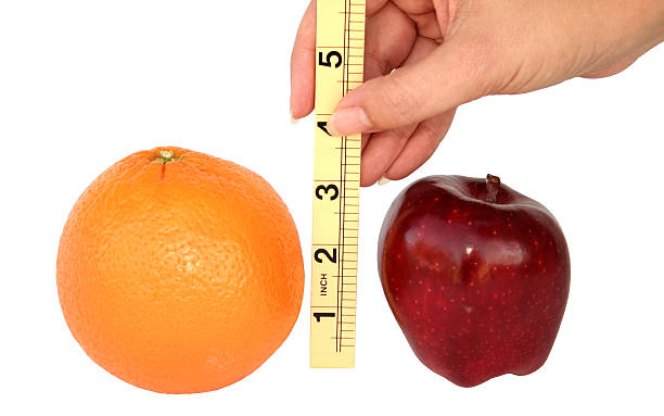 confrontare mele con arance - comparison apple orange isolated foto e immagini stock