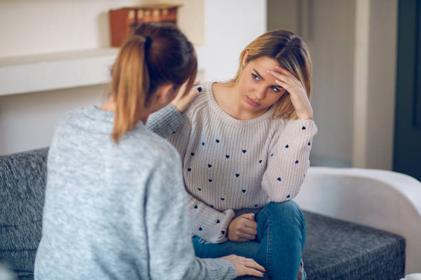 Lesbian couple having relationship difficulties Lesbian couple having relationship difficulties and trying to talk about it at home. sad gay stock pictures, royalty-free photos & images