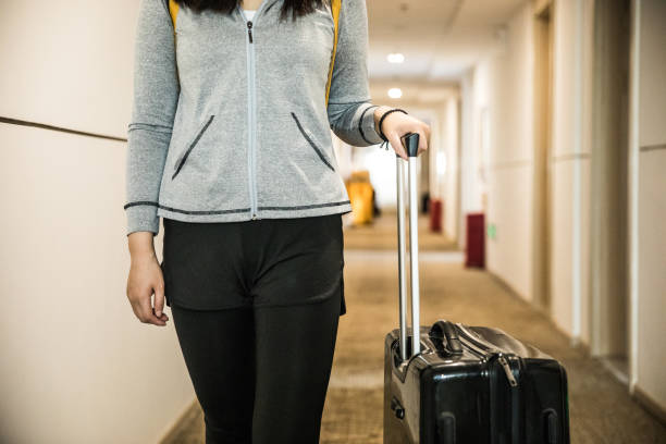 istock Walking in hotel corridor with luggage 944573902