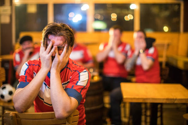istock Friends in a pub watching football 944574078