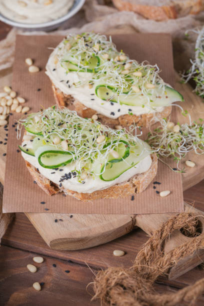 istock Healthy vegetarian bruschettas with bread, micro greens, hummus, cucumbers and pine nuts 944577458