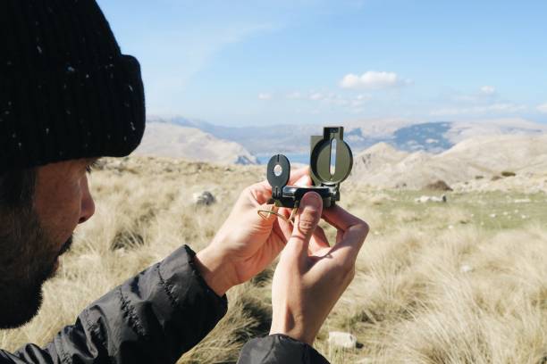 istock Young man navigate compass / outdoor camping 944578296
