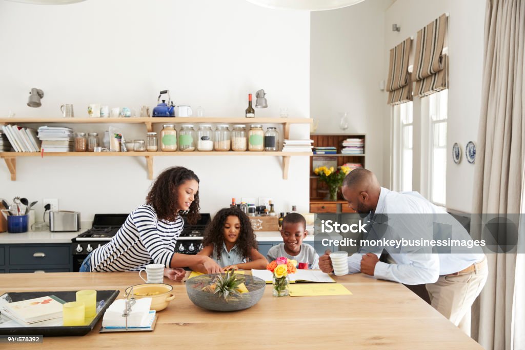 Young black family busy together in their kitchen Family Stock Photo