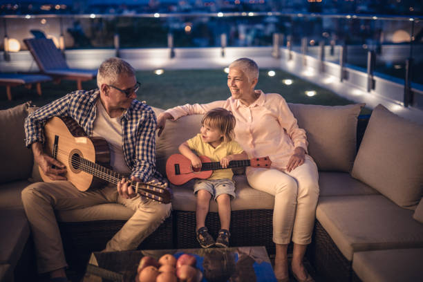istock Grandpa, I am playing a guitar just like you! 944581130
