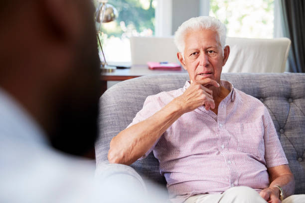 istock Senior man with depression having therapy with psychologist 944582316